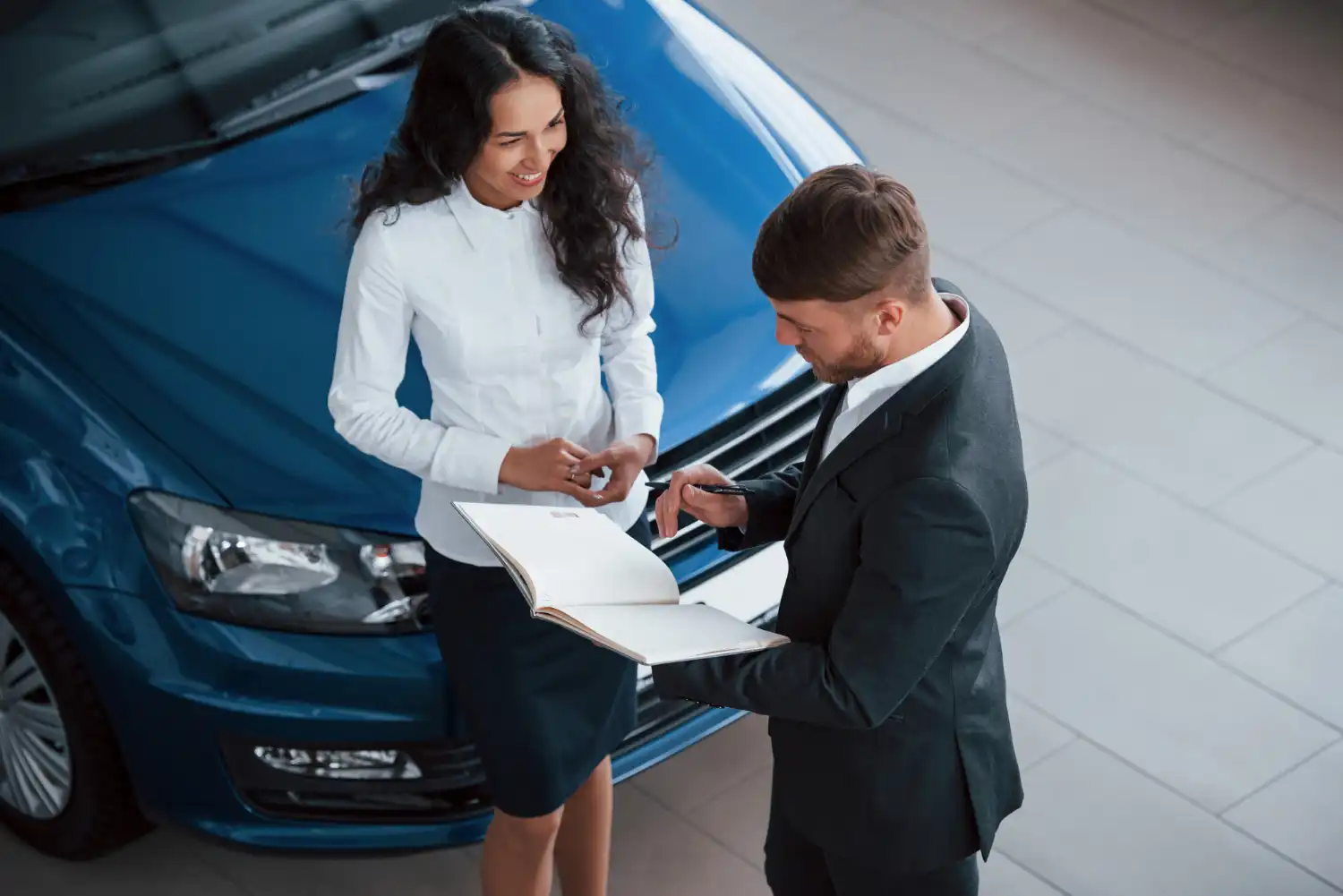 Family with car and insurance documents